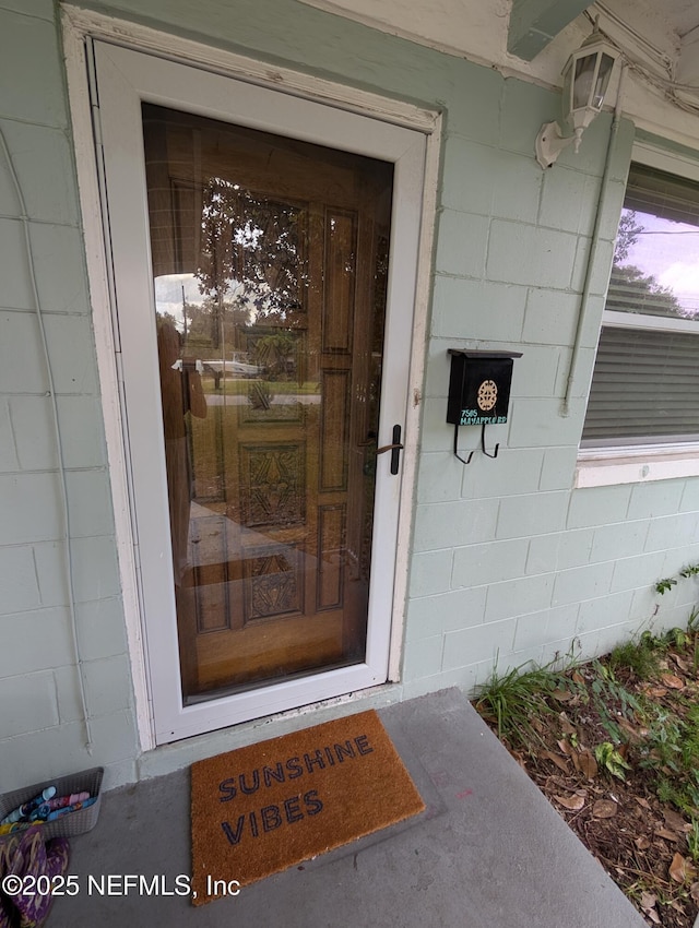 7505 Mayapple Rd, Jacksonville, FL 32211 - doorway to property with concrete block siding