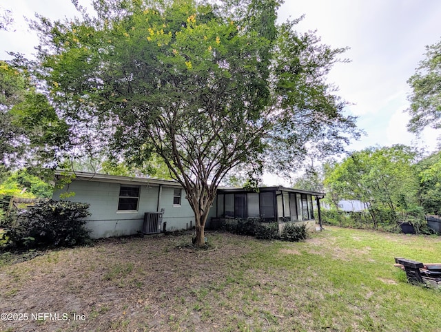 7505 Mayapple Rd, Jacksonville, FL 32211 - rear view of house with a sunroom and a yard