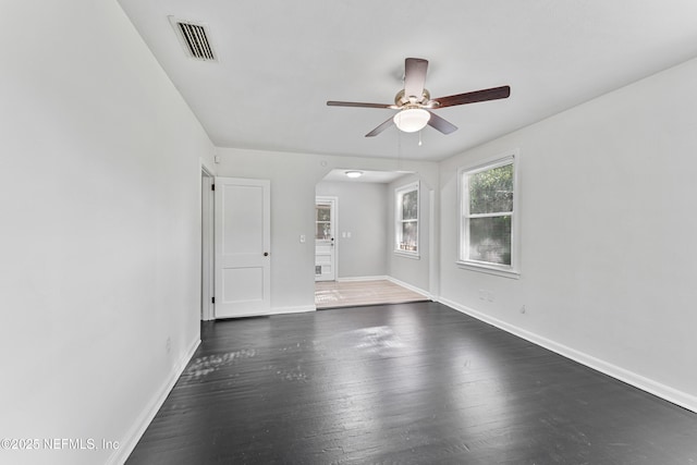 431 W 62nd St, Jacksonville, FL 32208 - empty room featuring ceiling fan, arched walkways, and dark wood-style flooring