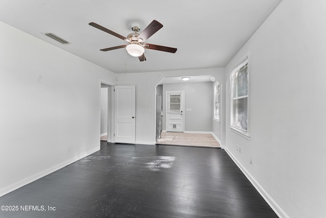 431 W 62nd St, Jacksonville, FL 32208 - spare room featuring arched walkways, ceiling fan, and wood finished floors