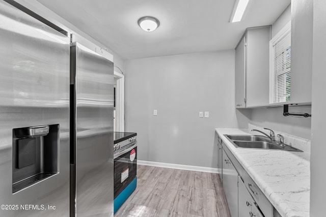 431 W 62nd St, Jacksonville, FL 32208 - kitchen featuring stainless steel appliances, light wood finished floors, light countertops, and gray cabinetry