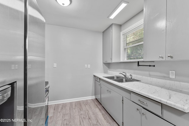 431 W 62nd St, Jacksonville, FL 32208 - kitchen with freestanding refrigerator, light wood finished floors, and stove