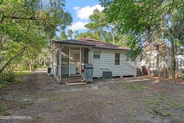 431 W 62nd St, Jacksonville, FL 32208 - rear view of property with a sunroom, entry steps, and a chimney