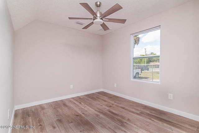 209 N 7th St, Palatka, FL 32177 - unfurnished room featuring wood finished floors, ceiling fan, a textured ceiling, and lofted ceiling