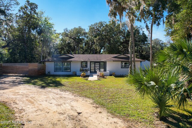5062 N Ocean Shore Blvd, Palm Coast, FL 32137 - view of front of property with dirt driveway and stucco siding