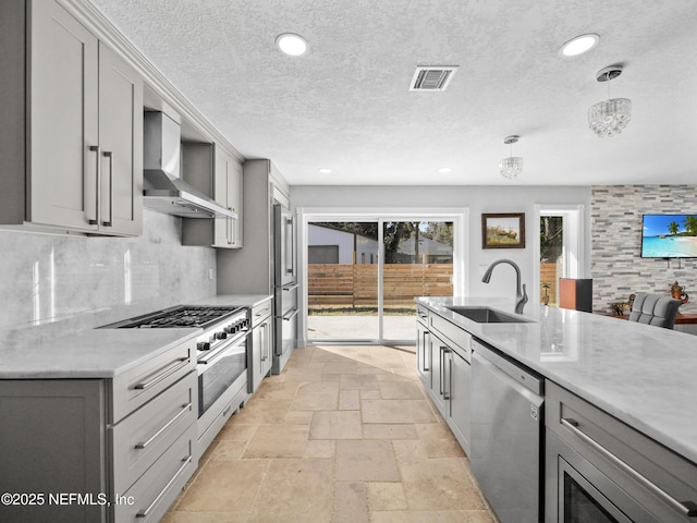 5062 N Ocean Shore Blvd, Palm Coast, FL 32137 - kitchen featuring high quality appliances, gray cabinets, wall chimney exhaust hood, stone tile floors, and recessed lighting