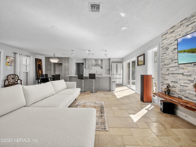 5062 N Ocean Shore Blvd, Palm Coast, FL 32137 - living area with stone tile floors, recessed lighting, and a textured ceiling