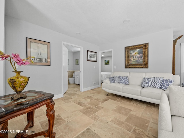 5062 N Ocean Shore Blvd, Palm Coast, FL 32137 - living area featuring stone tile flooring and baseboards