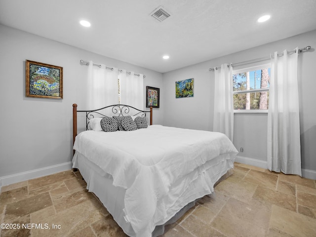 5062 N Ocean Shore Blvd, Palm Coast, FL 32137 - bedroom featuring stone tile flooring and recessed lighting