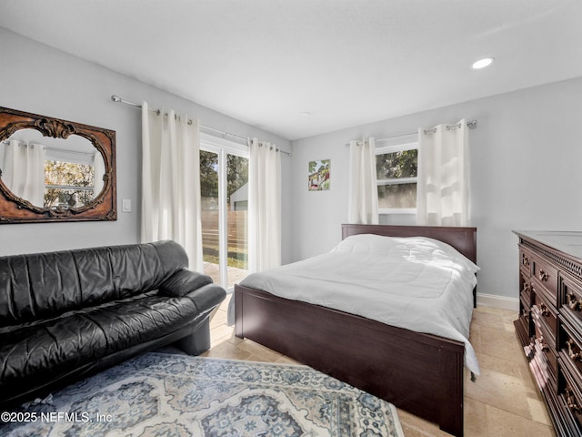 5062 N Ocean Shore Blvd, Palm Coast, FL 32137 - bedroom with access to exterior, stone tile floors, and recessed lighting