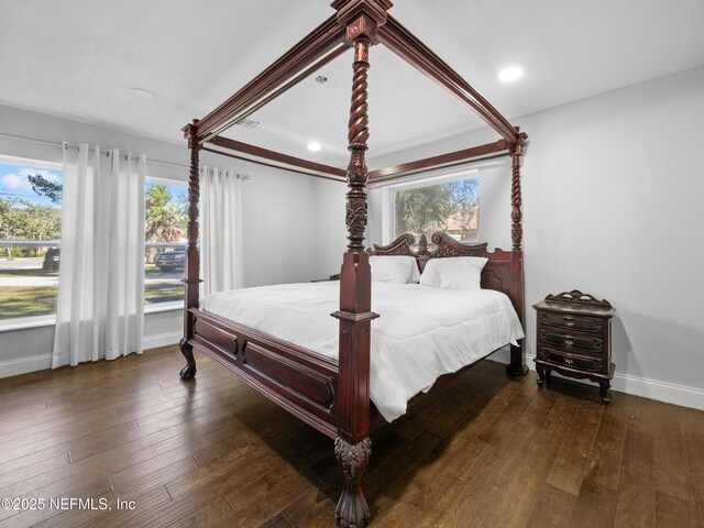 5062 N Ocean Shore Blvd, Palm Coast, FL 32137 - bedroom with multiple windows, wood-type flooring, and recessed lighting