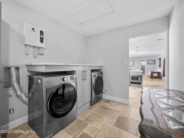 5062 N Ocean Shore Blvd, Palm Coast, FL 32137 - laundry room featuring attic access, washing machine and dryer, and stone tile flooring
