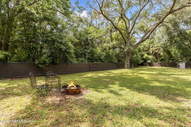 86759 Hester Dr, Yulee, FL 32097 - fenced backyard with a fire pit