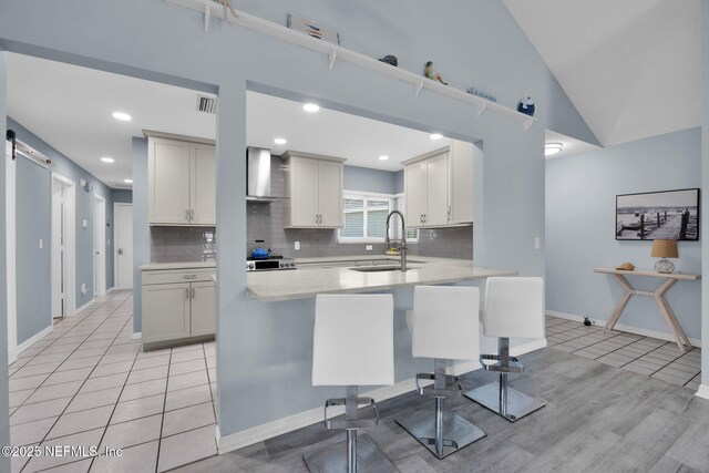 107 Hammock Cir, Saint Augustine, FL 32084 - kitchen with backsplash, wall chimney exhaust hood, light tile patterned flooring, and recessed lighting