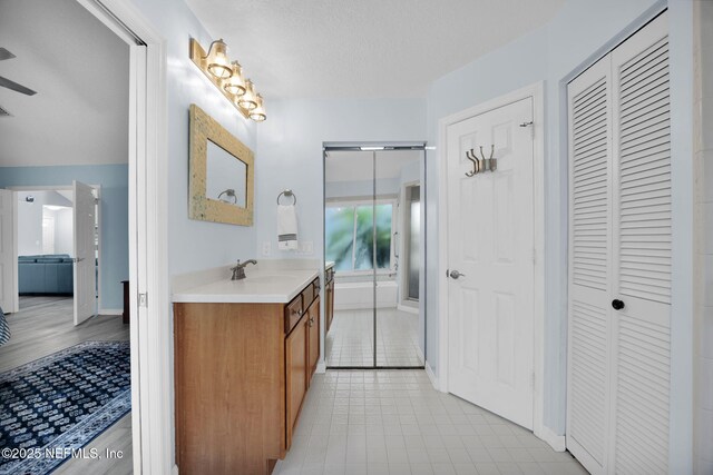 107 Hammock Cir, Saint Augustine, FL 32084 - bathroom featuring a closet, vanity, and ceiling fan