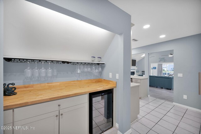 107 Hammock Cir, Saint Augustine, FL 32084 - kitchen with wine cooler, white cabinetry, a ceiling fan, wood counters, and light tile patterned floors
