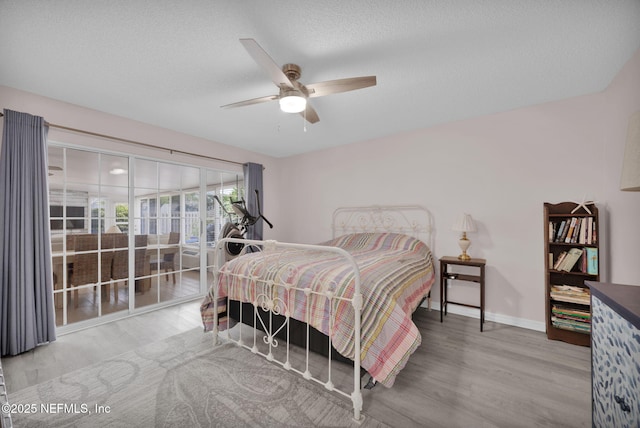 107 Hammock Cir, Saint Augustine, FL 32084 - bedroom with wood finished floors, access to exterior, a ceiling fan, and a textured ceiling