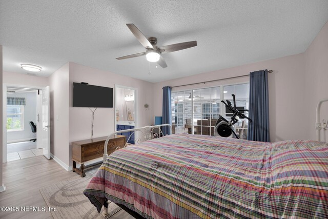 107 Hammock Cir, Saint Augustine, FL 32084 - bedroom with multiple windows, light wood-type flooring, a textured ceiling, and a ceiling fan