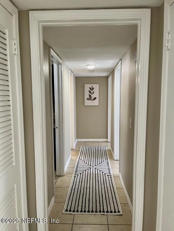 1713 El Camino Rd Unit 3, Jacksonville, FL 32216 - corridor featuring light tile patterned floors and baseboards