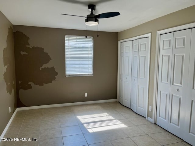 1713 El Camino Rd Unit 3, Jacksonville, FL 32216 - unfurnished bedroom featuring multiple closets, light tile patterned flooring, and a ceiling fan
