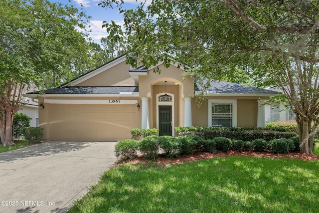 13967 Devan Lee Dr N, Jacksonville, FL 32226 - view of front of property with stucco siding, a garage, driveway, and a front yard