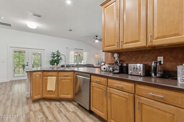 13967 Devan Lee Dr N, Jacksonville, FL 32226 - kitchen with stainless steel dishwasher, backsplash, vaulted ceiling, plenty of natural light, and ceiling fan