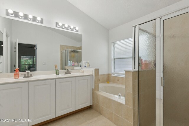 13967 Devan Lee Dr N, Jacksonville, FL 32226 - bathroom with lofted ceiling, a stall shower, double vanity, a bath, and tile patterned floors
