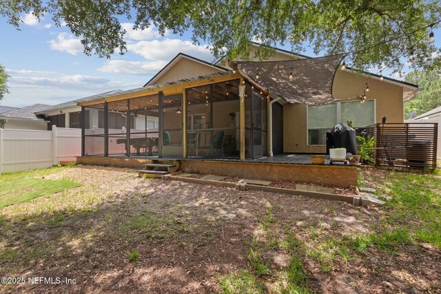 13967 Devan Lee Dr N, Jacksonville, FL 32226 - back of property with a sunroom and stucco siding
