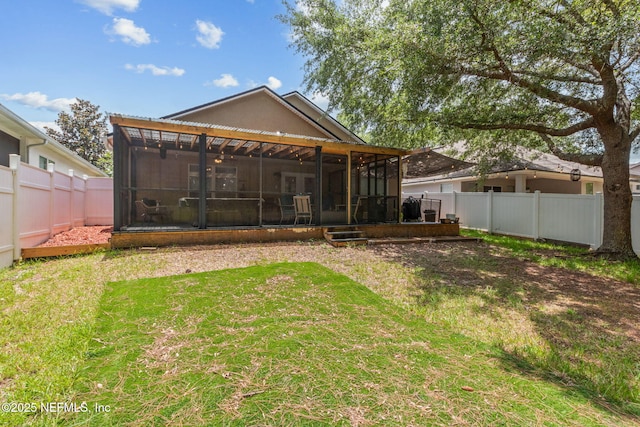 13967 Devan Lee Dr N, Jacksonville, FL 32226 - rear view of house featuring a sunroom, a fenced backyard, and stucco siding