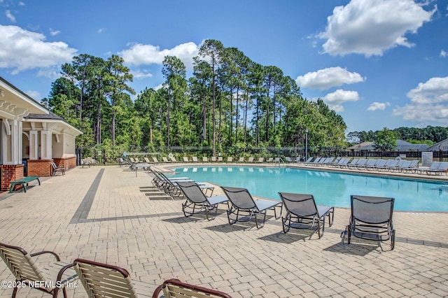 13967 Devan Lee Dr N, Jacksonville, FL 32226 - community pool with a patio area and view of wooded area