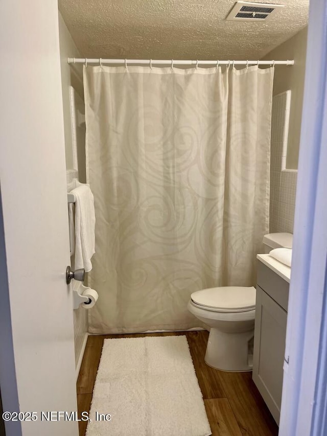 1716 El Camino Rd Unit 3, Jacksonville, FL 32216 - bathroom with wood finished floors, vanity, a textured ceiling, and curtained shower