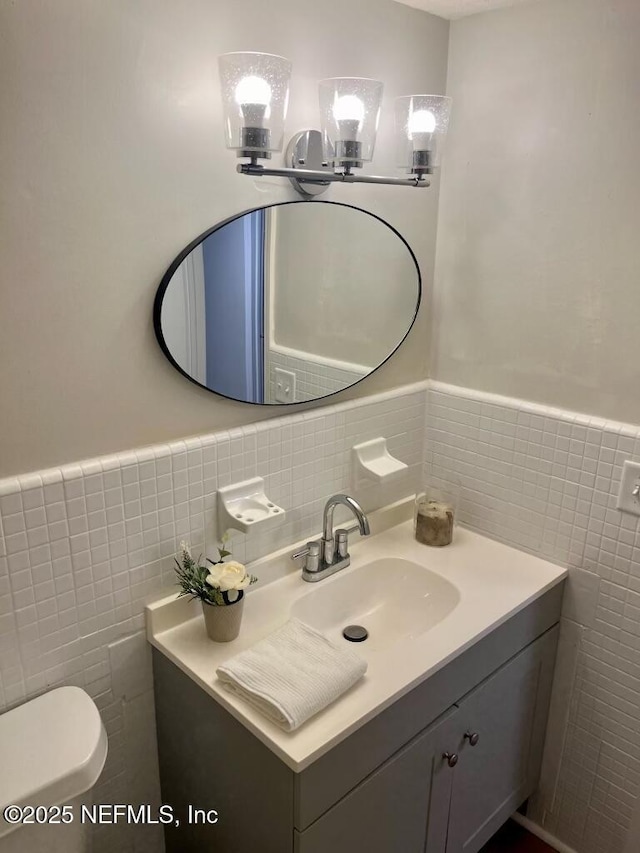 1716 El Camino Rd Unit 3, Jacksonville, FL 32216 - bathroom featuring tile walls, vanity, and a wainscoted wall