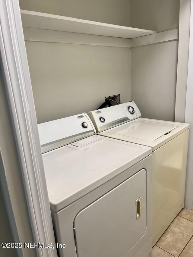 1716 El Camino Rd Unit 3, Jacksonville, FL 32216 - laundry area with washer and clothes dryer and light tile patterned flooring