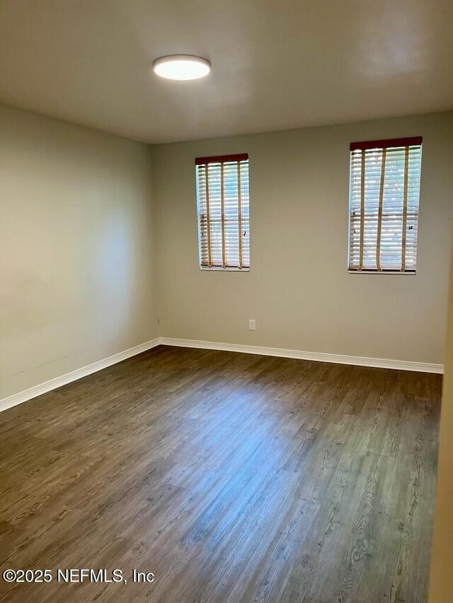 1716 El Camino Rd Unit 3, Jacksonville, FL 32216 - spare room featuring dark wood finished floors and baseboards