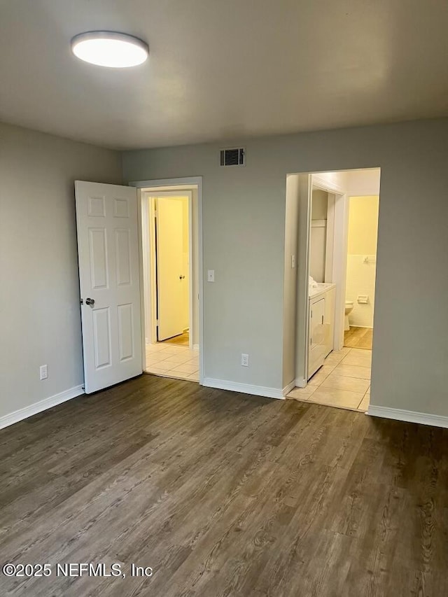 1716 El Camino Rd Unit 3, Jacksonville, FL 32216 - unfurnished bedroom with wood finished floors, washing machine and dryer, and connected bathroom