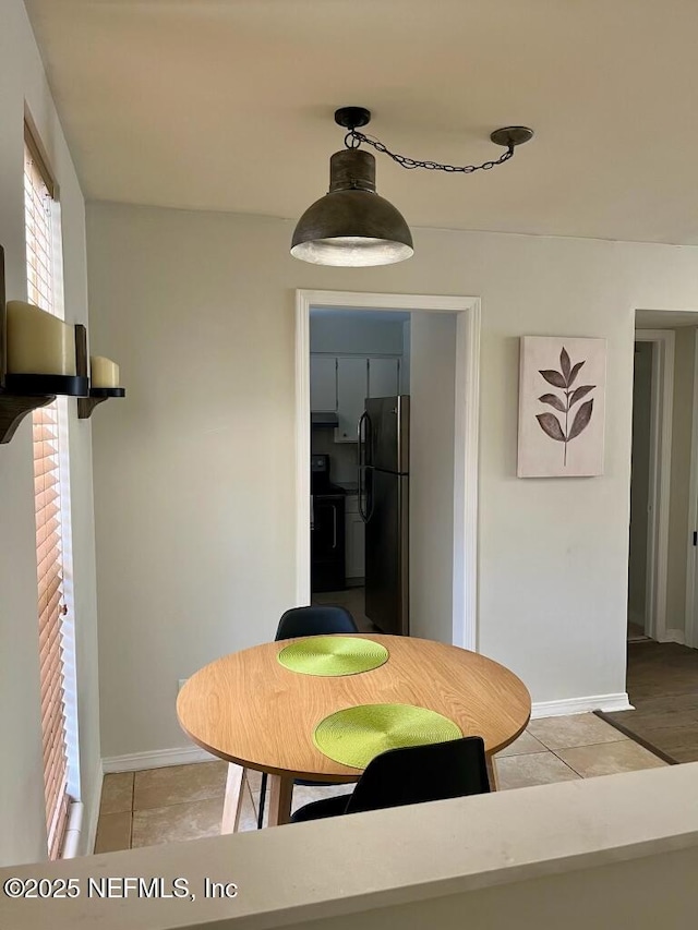 1716 El Camino Rd Unit 3, Jacksonville, FL 32216 - dining space with light tile patterned flooring and baseboards
