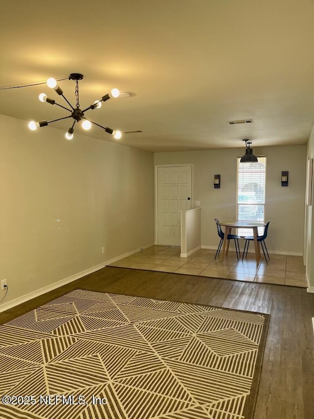 1716 El Camino Rd Unit 3, Jacksonville, FL 32216 - unfurnished living room with a chandelier and wood finished floors