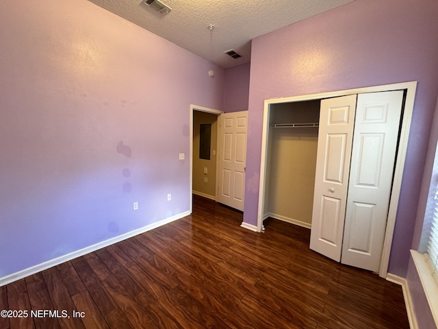 9626 Belda Way Unit 7, Jacksonville, FL 32257 - unfurnished bedroom featuring dark wood-style flooring, a closet, and a textured ceiling