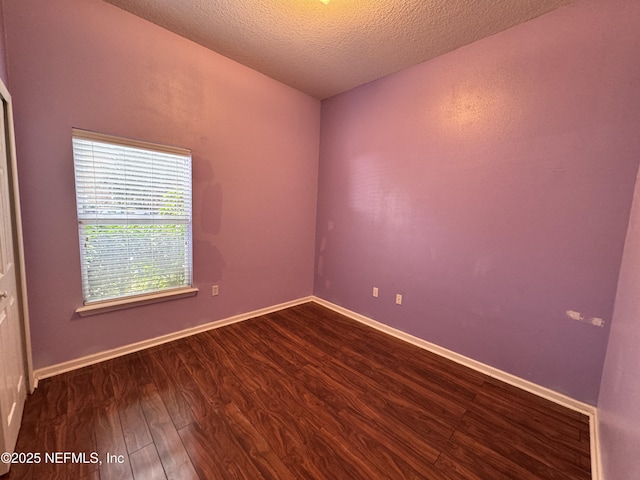9626 Belda Way Unit 7, Jacksonville, FL 32257 - empty room with dark wood-style floors and a textured ceiling