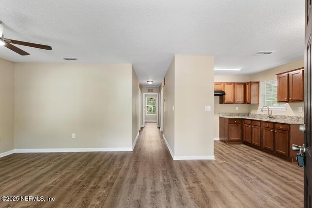 5522 Paris Ave, Jacksonville, FL 32209 - kitchen featuring open floor plan, ceiling fan, wood finished floors, under cabinet range hood, and a textured ceiling