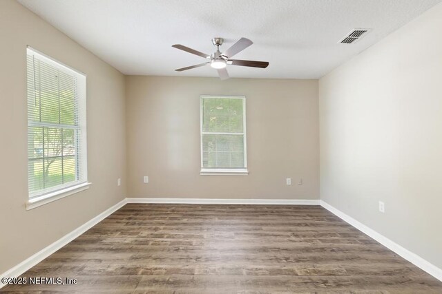 5522 Paris Ave, Jacksonville, FL 32209 - empty room featuring plenty of natural light, a ceiling fan, and wood finished floors