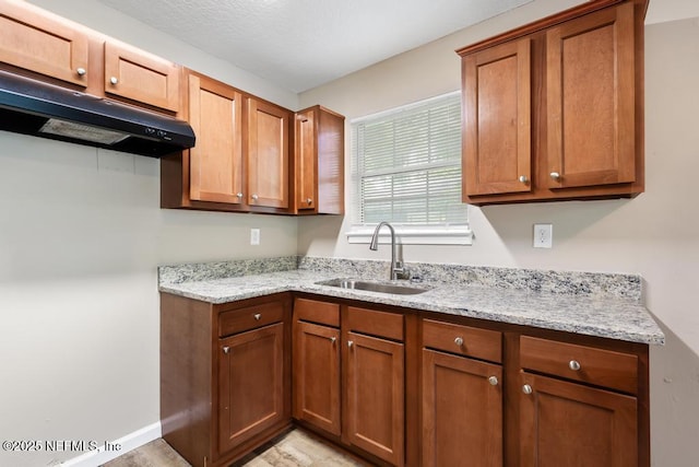 5522 Paris Ave, Jacksonville, FL 32209 - kitchen with light stone countertops, brown cabinets, and under cabinet range hood