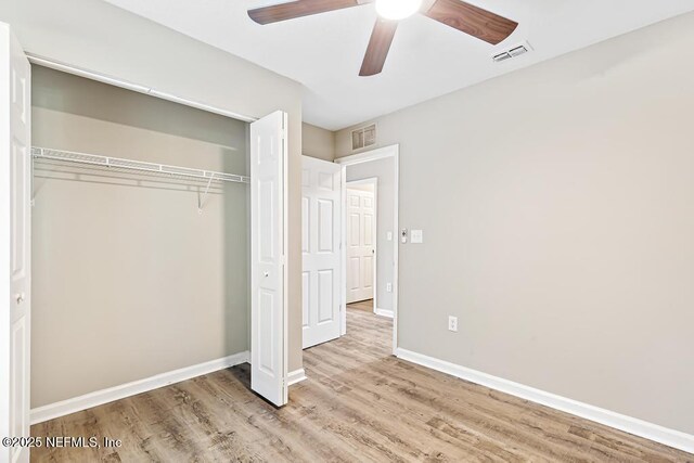 5522 Paris Ave, Jacksonville, FL 32209 - unfurnished bedroom featuring wood finished floors, a closet, and a ceiling fan