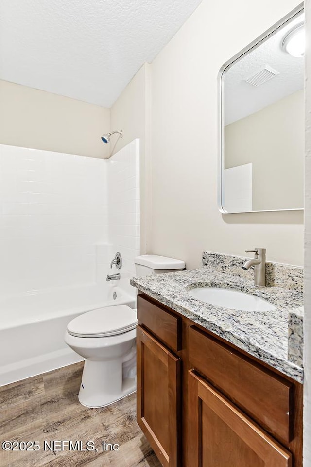 5522 Paris Ave, Jacksonville, FL 32209 - full bathroom featuring wood finished floors, vanity, shower / washtub combination, and a textured ceiling