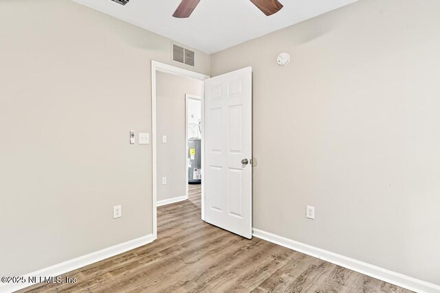 5522 Paris Ave, Jacksonville, FL 32209 - unfurnished room with ceiling fan, wood finished floors, a smoke detector, and electric water heater