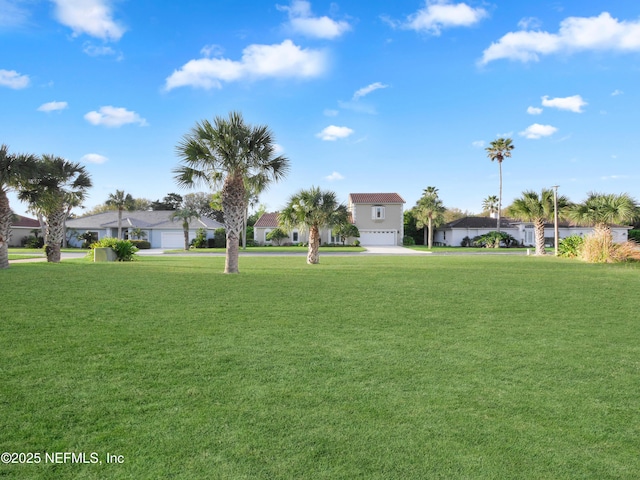 30 Bermuda Run Way, Saint Augustine Beach, FL 32080 - view of green lawn featuring a garage, driveway, and a residential view