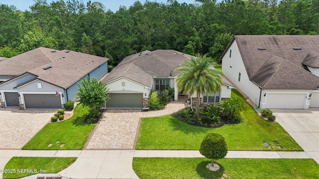 435 Tree Side Ln, Ponte Vedra, FL 32081 - view of front of house featuring driveway, a front lawn, and stucco siding