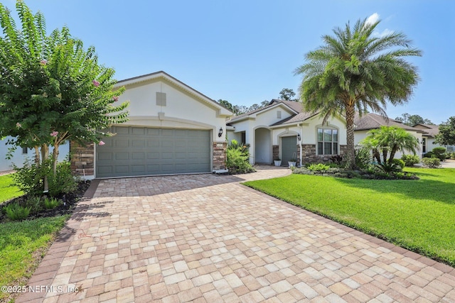435 Tree Side Ln, Ponte Vedra, FL 32081 - view of front of property with decorative driveway, stucco siding, stone siding, and a front yard