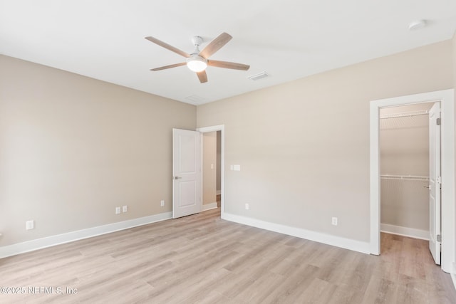 6334 Salado Rd, Saint Augustine, FL 32080 - unfurnished bedroom with light wood-style floors, a walk in closet, a closet, and a ceiling fan