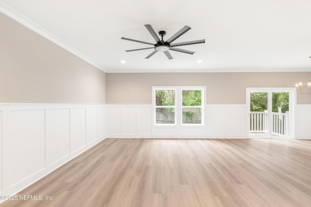6334 Salado Rd, Saint Augustine, FL 32080 - spare room featuring a chandelier, a decorative wall, ceiling fan, healthy amount of natural light, and crown molding